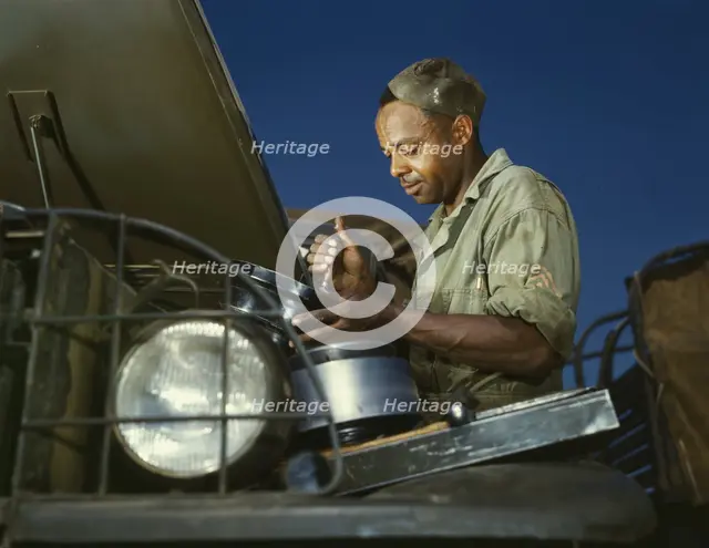 A good job in the air cleaner of an army truck, Fort Knox, Ky., 1942. Creator: Alfred T Palmer.