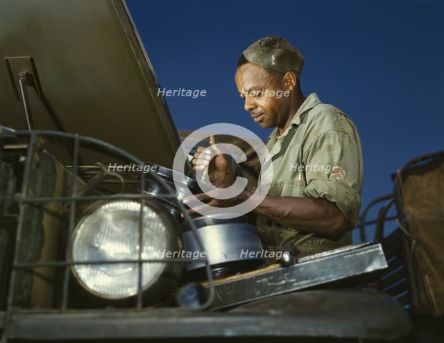 A good job in the air cleaner of an army truck, Fort Knox, Ky., 1942. Creator: Alfred T Palmer.