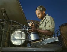 A good job in the air cleaner of an army truck, Fort Knox, Ky., 1942. Creator: Alfred T Palmer