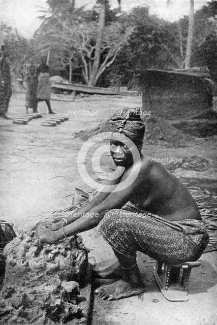 A Gold Coast potter and her clay, Ghana, West Africa, 1922.Artist: PA McCann