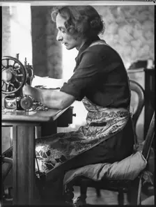 A glover or glove maker working at a sewing machine, Woodstock, Oxfordshire, 1920-1940. Creator: George R Long