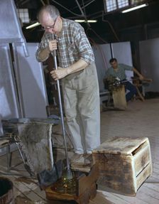 A glass blower at Strombergshyttan's glassworks, Sweden, 1950s. Creator: Unknown