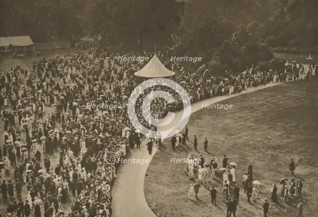 'A Glimpse of One of the Annual Royal Garden Parties Among The Timbered Lawns of Buckingham Palace', Creator: Unknown.