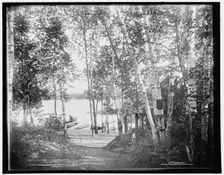 A glimpse of Raquette Lake from St. Hubert's Isle, Adirondack Mountains, c1902. Creator: William H. Jackson
