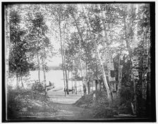 A glimpse of Raquette Lake from St. Hubert's Isle, Adirondack Mountains, c1902. Creator: William H. Jackson