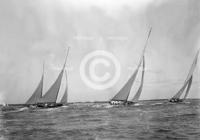 A group of 12 Metres sailing yachts racing on windward leg in good wind, 1933. Creator: Kirk & Sons of Cowes.
