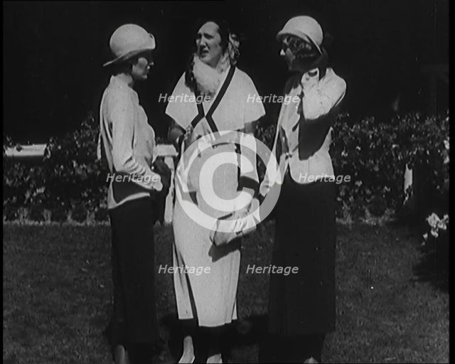 A Group of Three Female Civilians Wearing Fashionable Clothes Standing in a Garden, 1929. Creator: British Pathe Ltd.