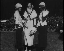 A Group of Three Female Civilians Wearing Fashionable Clothes Standing in a Garden, 1929. Creator: British Pathe Ltd