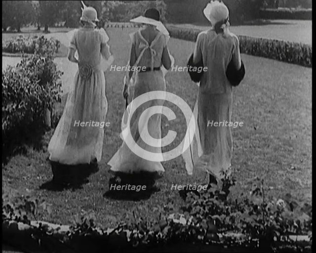 A Group of Three Female Civilians Wearing Fashionable Clothes Standing in a Garden, 1929. Creator: British Pathe Ltd.