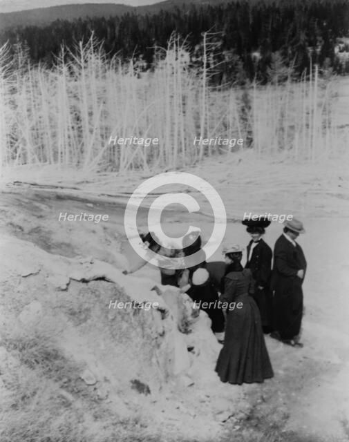 A group of tourists explore land formations in Yellowstone National Park, 1903. Creator: Frances Benjamin Johnston.