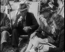 A Group of Two Men and Two Women Sitting on Deckchairs on the Beach at Brighton and Eating..., 1939 Creator: British Pathe Ltd