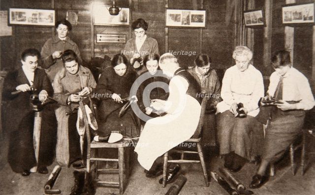 A group of women receive a lesson in boot repairing, World War I, c1914-c1918. Creator: S and G.