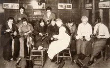 A group of women receive a lesson in boot repairing, World War I, c1914-c1918. Creator: S and G