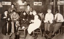 A group of women receive a lesson in boot repairing, World War I, c1914-c1918. Creator: S and G