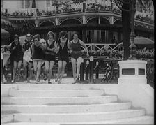 A Group of Young Female Civilians Running down Some Steps Wearing Swimsuits, 1920. Creator: British Pathe Ltd
