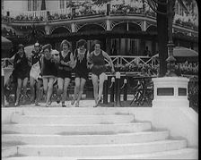 A Group of Young Female Civilians Running down Some Steps Wearing Swimsuits, 1920. Creator: British Pathe Ltd