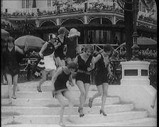 A Group of Young Female Civilians Running down Some Steps Wearing Swimsuits, 1920. Creator: British Pathe Ltd