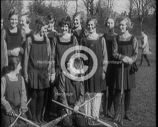 A Group of Young Female Civilians Wearing Gymslips Holding Lacrosse Sticks, 1920. Creator: British Pathe Ltd.