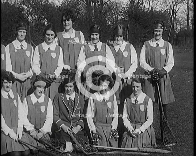 A Group of Young Female Civilians Wearing Gymslips Holding Lacrosse Sticks, 1920. Creator: British Pathe Ltd.