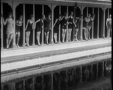 A Group of Young Female Civilians Wearing Short Swimsuits and Heeled Shoes Emerging from..., 1920. Creator: British Pathe Ltd