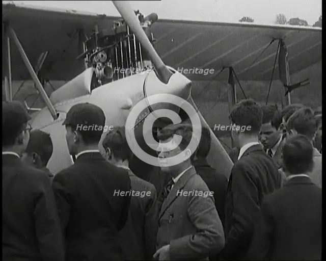 A Group of Young Male British Civilians Admiring an Airplane On an Airfield, 1920s. Creator: British Pathe Ltd.