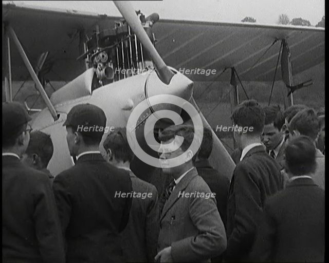 A Group of Young Male British Civilians Admiring an Airplane On an Airfield, 1920s. Creator: British Pathe Ltd.