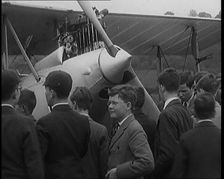 A Group of Young Male British Civilians Admiring an Airplane On an Airfield, 1920s. Creator: British Pathe Ltd