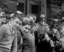 A Group of American Children Civilians Gathering Outside an Official Building with a Male..., 1930. Creator: British Pathe Ltd