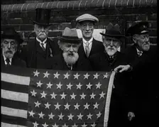 A Group of American Civil War Veterans Stand Together Holding the American Flag, 1924. Creator: British Pathe Ltd