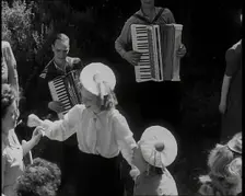 A Group of British Girls Dancing As Two British Men Play Accordion Music, 1938. Creator: British Pathe Ltd