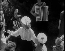 A Group of British Girls Dancing As Two British Men Play Accordion Music, 1938. Creator: British Pathe Ltd