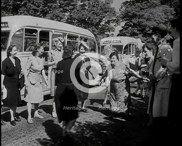 A Group of British Women Dancing On a Grass Verge in the Sunshine With Two Buses Parked..., 1938. Creator: British Pathe Ltd.
