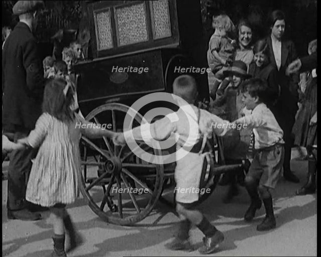 A Group of Civilian Children Dancing Around a Hurdy Gurdy, 1920. Creator: British Pathe Ltd.