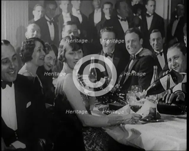 A Group of Fashionable Young People Sitting at a Table Drinking Champagne, 1924. Creator: British Pathe Ltd.