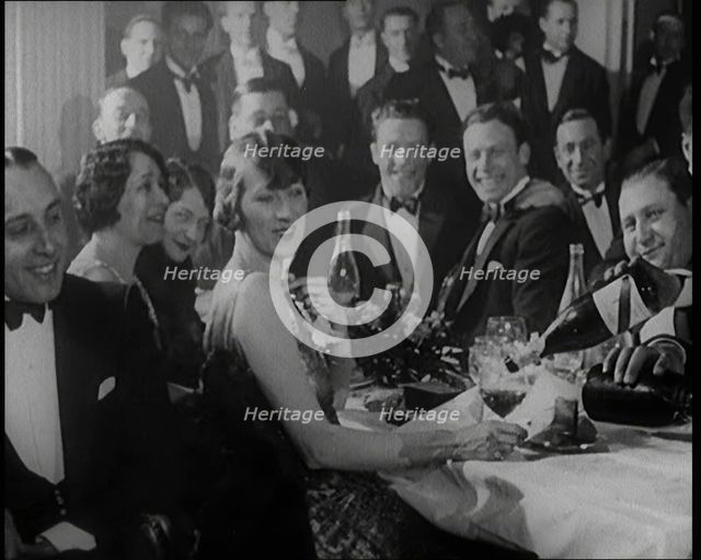 A Group of Fashionable Young People Sitting at a Table Drinking Champagne, 1924. Creator: British Pathe Ltd.