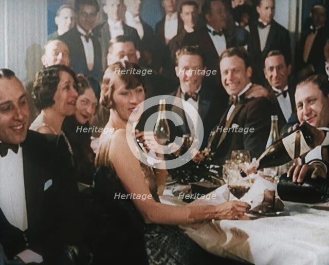 A Group of Fashionable Young People Sitting at a Table Drinking Champagne, 1924. Creator: British Pathe Ltd.