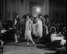 A Group of Female Civilians Modelling Various Glamorous Outfits in a Fashion Parade, 1920. Creator: British Pathe Ltd