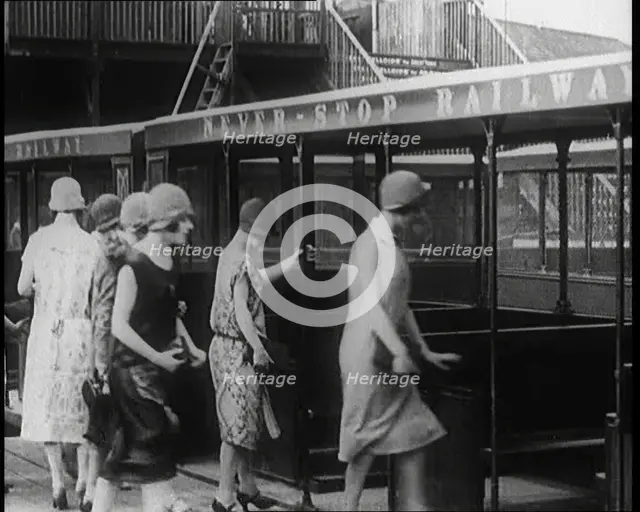 A Group of Female Civilians Board a Carriage of the 'Never Stop Railway', 1924. Creator: British Pathe Ltd.