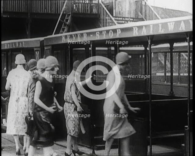 A Group of Female Civilians Board a Carriage of the 'Never Stop Railway', 1924. Creator: British Pathe Ltd.