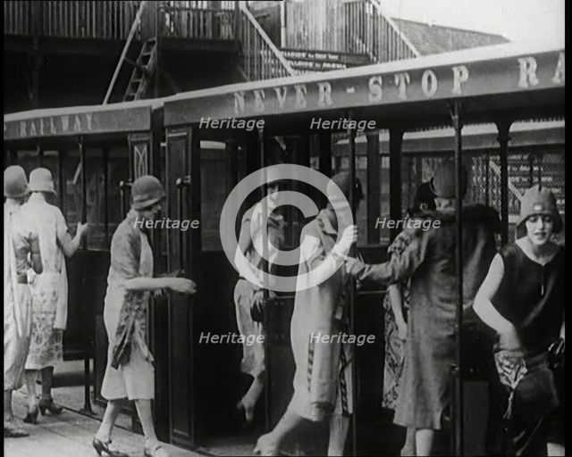 A Group of Female Civilians Board a Carriage of the 'Never Stop Railway', 1924. Creator: British Pathe Ltd.