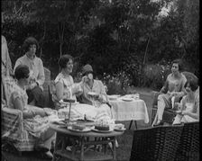 A Group of Female Civilians Drinking Tea and Eating Cakes in the Garden, 1926. Creator: British Pathe Ltd