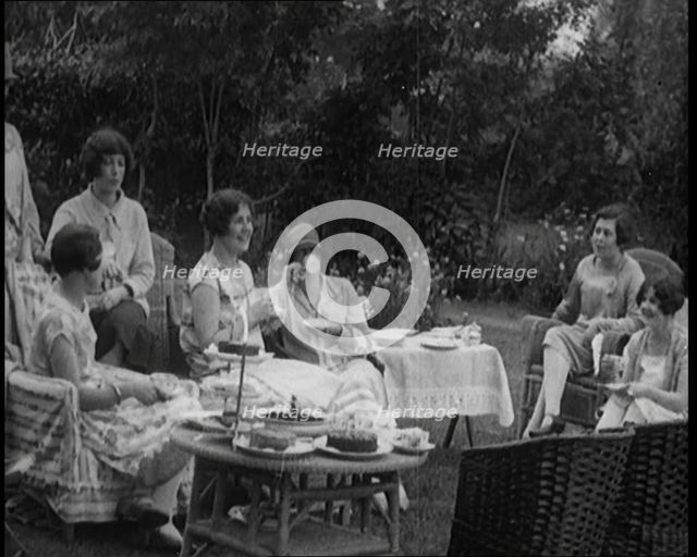 A Group of Female Civilians Drinking Tea and Eating Cakes in the Garden, 1926. Creator: British Pathe Ltd.