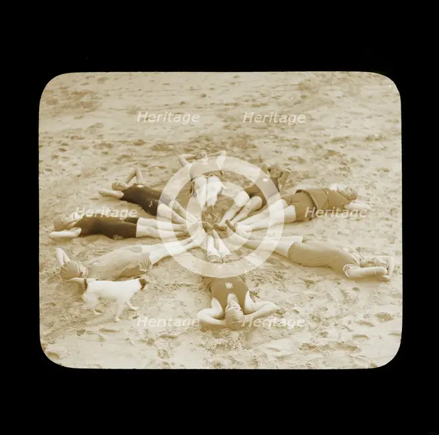 A group of female swimmers lying in a circle on the beach probably at Clacton-on-Sea..., 1920s.  Creator: Norman Kingsley Harrison.