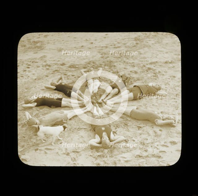 A group of female swimmers lying in a circle on the beach probably at Clacton-on-Sea..., 1920s.  Creator: Norman Kingsley Harrison.
