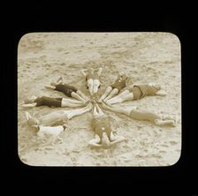 A group of female swimmers lying in a circle on the beach probably at Clacton-on-Sea..., 1920s. Creator: Norman Kingsley Harrison