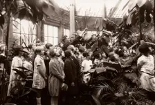 A group of girls are shown the features of a conservatory, York, Yorkshire, 1929