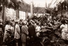 A group of girls are shown the features of a conservatory, York, Yorkshire, 1929