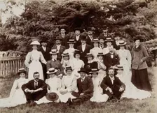 A group of hospital staff, including nurses wearing matching straw hats, standing outdoors. Creator: Unknown
