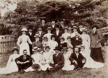 A group of hospital staff, including nurses wearing matching straw hats, standing outdoors. Creator: Unknown