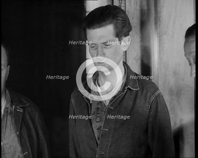 A group of Male Americans Civilians Wearing Prisoners Outfits Being Escorted Into a Room..., 1930. Creator: British Pathe Ltd.